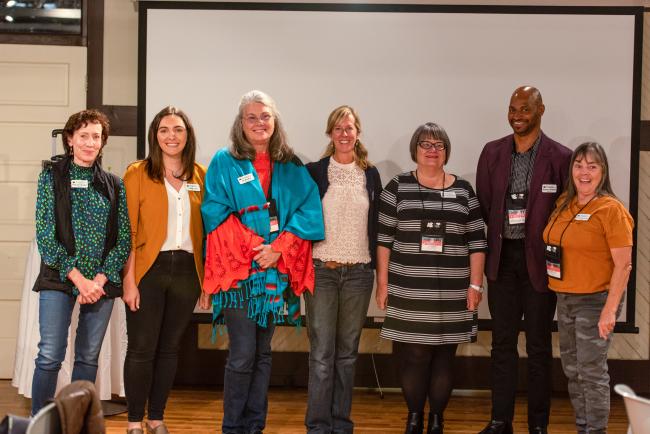 CCI's Colorado Change Leader cohort, seven people smiling at camera at CCI's annual summit held in Steamboat Springs
