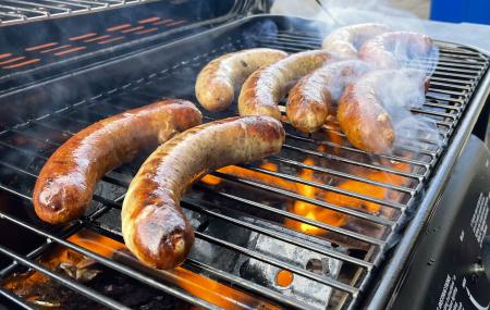 sausages cooking on a grill