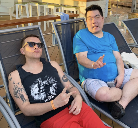 Andy Thomas and Nick Abowitz are hanging out in lounge chairs on the deck of a cruise ship.