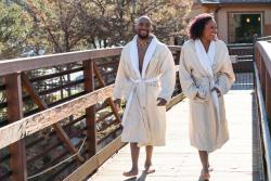 Two people walking across a bridge at hot springs