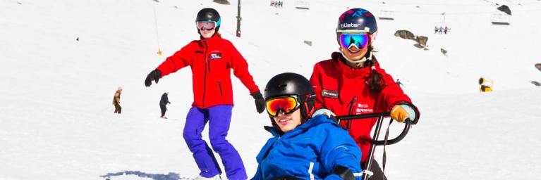 Man smiling while adaptive skiing