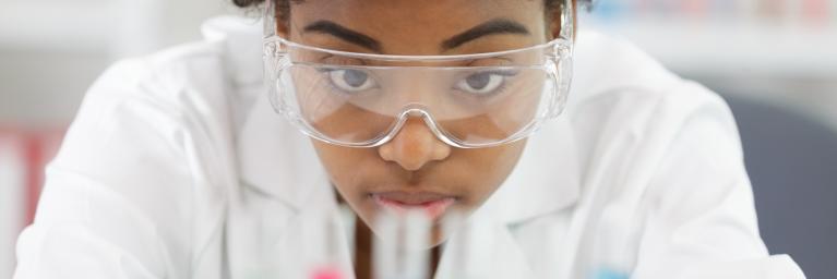 Female scientist looking at test tubes