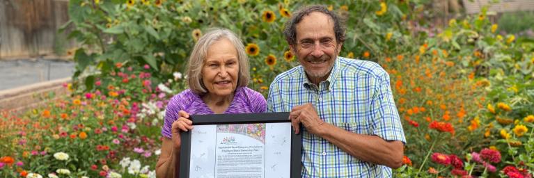 applewood seed founders stand in flowers