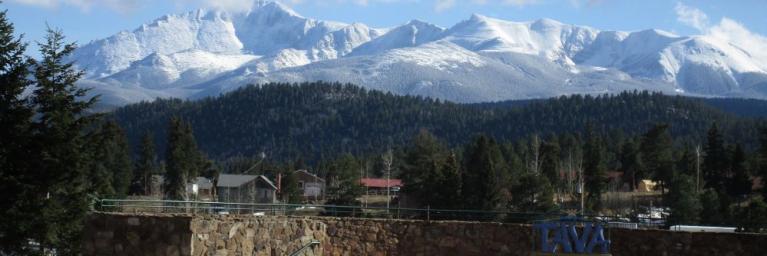 Panorama view of the City of Woodland Park with snow-capped mountains in the background.