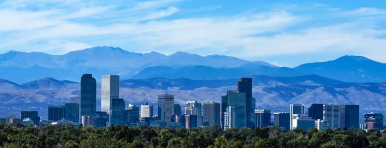 View of the Denver skyline with summer mountains in the background