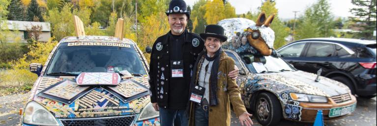 two people standing in front of decorated car outside of Steamboat Springs for Colorado Creative Industries Summit