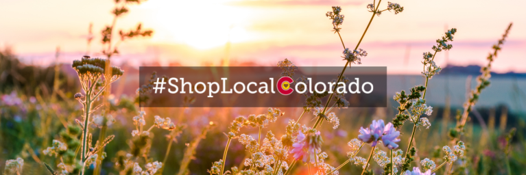 shoplocalcolorado written over flowers and mountains