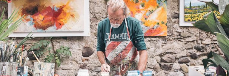 Man artist painting pottery