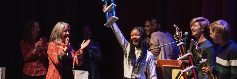 Poetry writer holds up her trophy