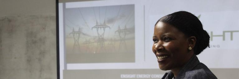 Black female CEO smiles while she gives a presentation
