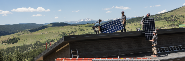 Namaste Solar Employees Installing Solar Panels with Mountain View