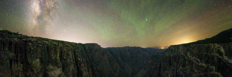 Starry sky above dark mountains