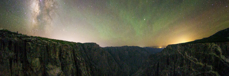 Starry sky above dark mountains 