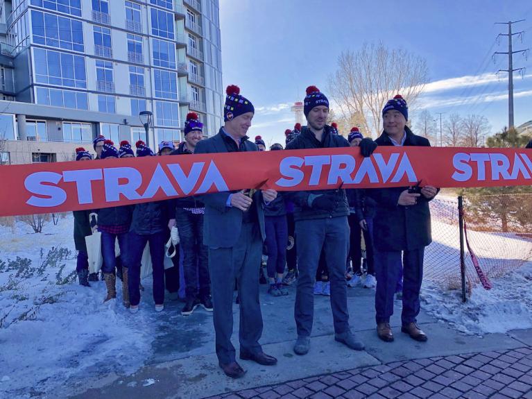 people cutting Strava ribbon outside in the winter