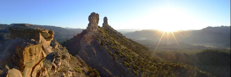 Sun rising over geologic formations