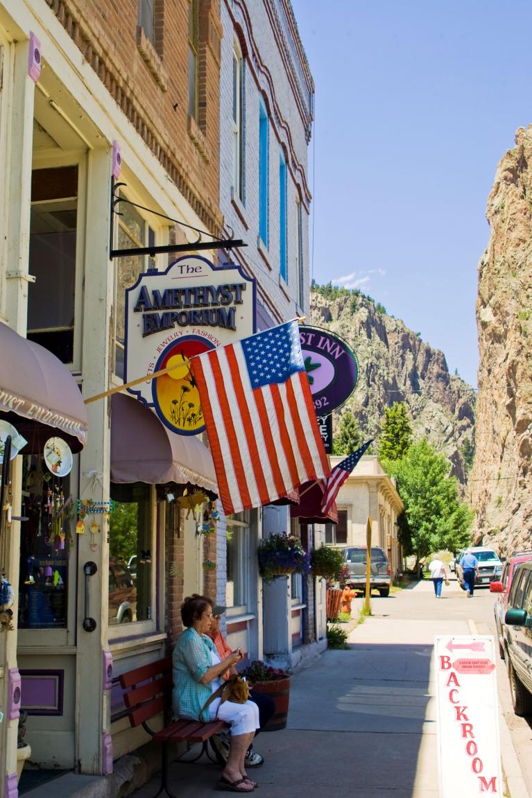 American flag hangs over a small shop in a mountain town