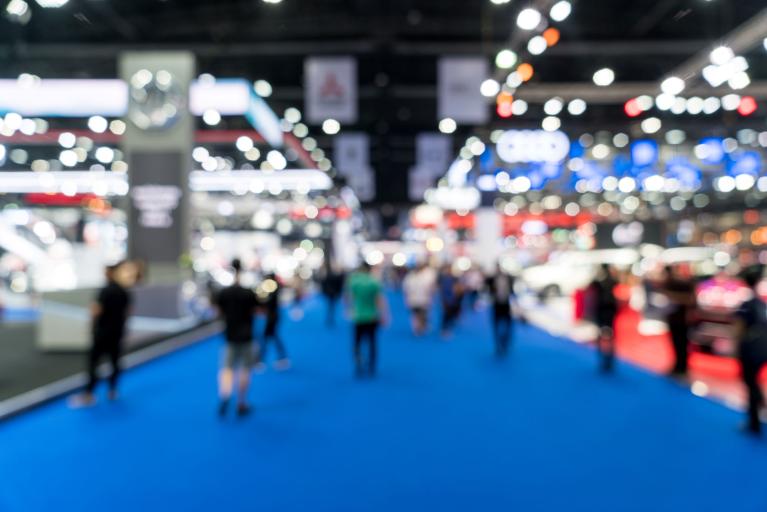 Blurred view of people walking through a trade show