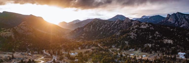The sun sets over the town of Estes Park on a summer evening.