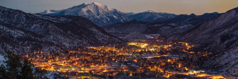City of Glenwood Springs lit up on a winter night from above.