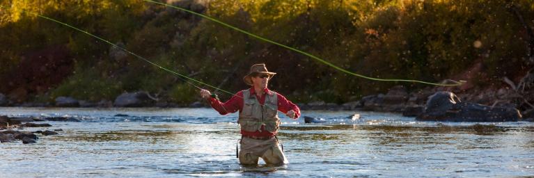 Fly fisherman in river near Glenwood Springs, Colorado