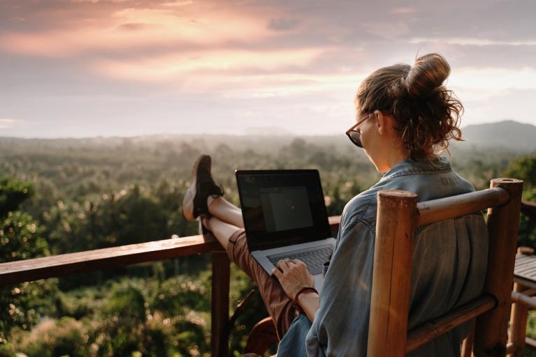 Employee sits on her back porch while she works from home