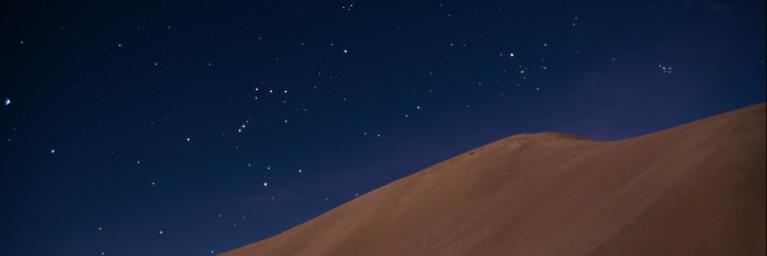 Starry night sky above the sand dunes at Great Sand Dunes National Park