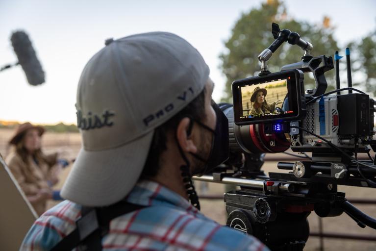 A member of the film crew films a scene on the set of The Engagement Plot in Colorado Springs.