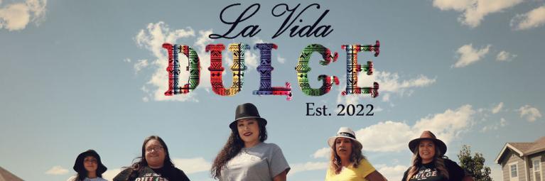 La Vida Dulce Team standing in Road with Logo