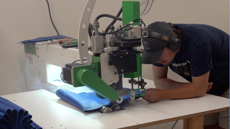 An Impact Fenders employee sews a boat fender. 