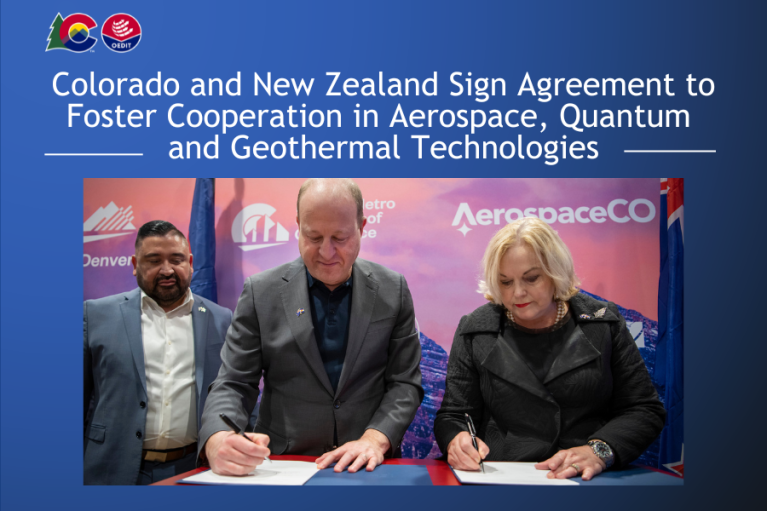 Press release image featuring Governor Polis and New Zealand representatives signing an agreement