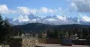 Panorama view of the City of Woodland Park with snow-capped mountains in the background.
