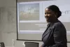 Black female CEO smiles while she gives a presentation