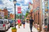 People walking down a street in downtown Leadville on a sunny day.