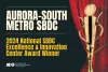 Aurora-South Metro Small Business Development Center Wins the 2024 National Small Business Development Center Excellence and Innovation Center Award from Small Business Administration with theatre curtain and trophy