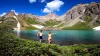 two people running into island lake outside of silverton, colorado
