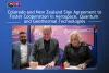 Press release image featuring Governor Polis and New Zealand representatives signing an agreement
